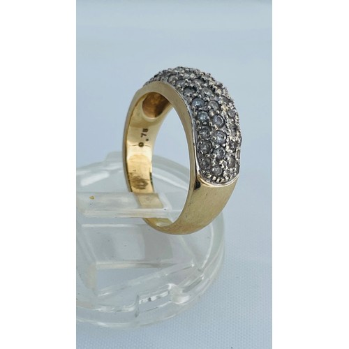 202 - A 9ct yellow gold dress ring, pave set with small round diamonds, estimated total weight of diamonds... 