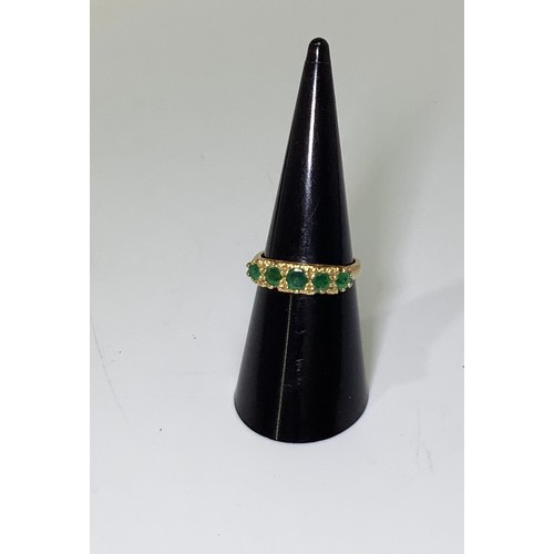 240 - An 18ct gold and five-stone emerald ring, graduated round faceted stones, 4.26g