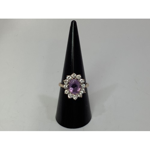 235 - A 9ct gold, amethyst and diamond dress ring, oval faceted amethyst measuring approximately 10x8mm, s... 