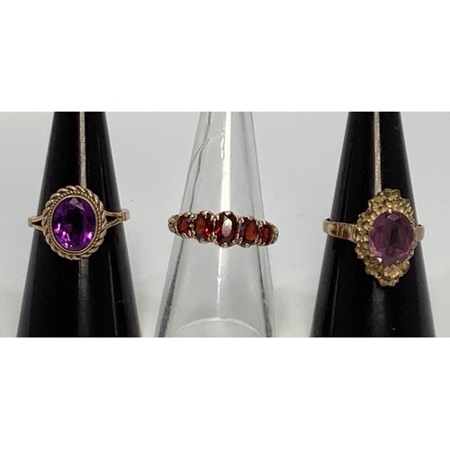 233 - A 9ct gold graduated five-stone garnet ring, together with two various 9ct gold solitaire amethyst r... 