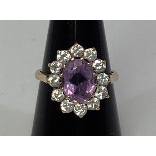 235 - A 9ct gold, amethyst and diamond dress ring, oval faceted amethyst measuring approximately 10x8mm, s... 