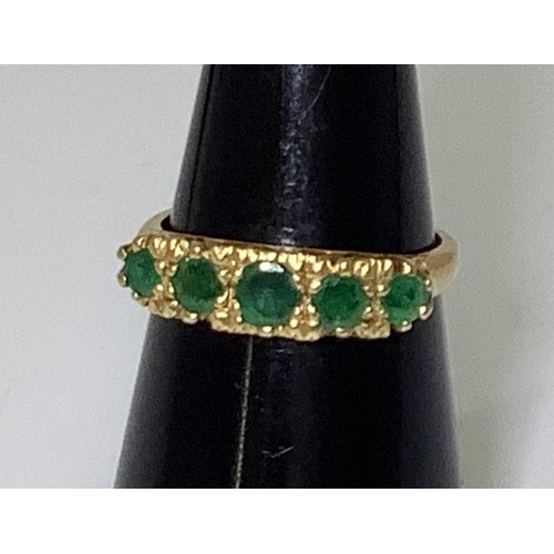 240 - An 18ct gold and five-stone emerald ring, graduated round faceted stones, 4.26g