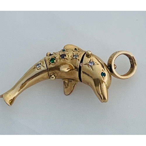 182 - A 9ct gold dolphin articulated pendant, set with various coloured stones to the body, and blue stone... 