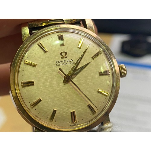 141 - A gents 10k gold filled Omega automatic wristwatch, the gold linen dial with applied gilt batons den... 