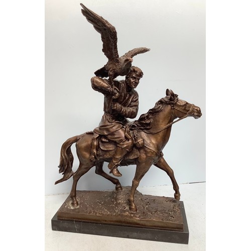 303 - A well-cast and patinated bronze figure of a mounted Arabian man with hunting hawk, unsigned, mounte... 