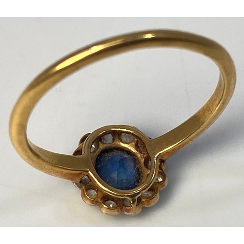 120 - An 18ct gold ring, centrally set with an oval faceted sapphire stone, surrounded by 12x small eight-... 