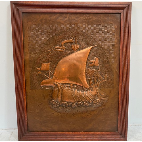 493 - An Arts and Crafts period copper panel with central embossed image of a ship at sea, possibly from a... 