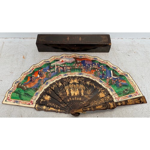 204 - A late 19th/early 20th century Chinese lacquered fan, the sticks with gilt scenes of figures convers... 