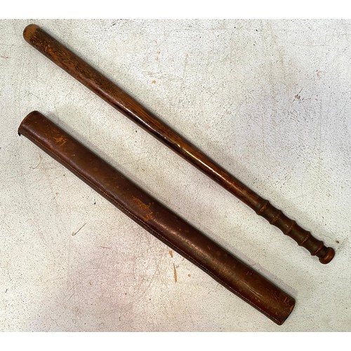 552 - A hardwood police truncheon, tapering to a fluted grip, with hard leather cylindrical sheath tube, 6... 