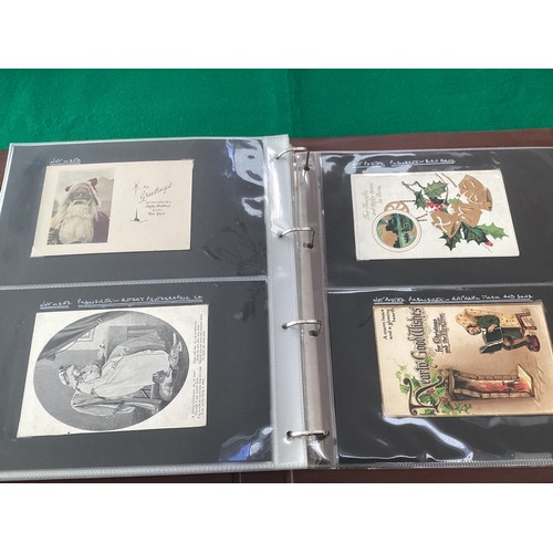 162 - Four albums – two containing more than 210 Christmas themed postcards, with a number featuring Fathe... 