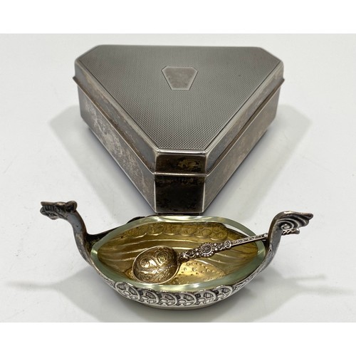 53 - A silver casket of triform with canted corners, engine-turned hinged cover enclosing gold satin inte... 