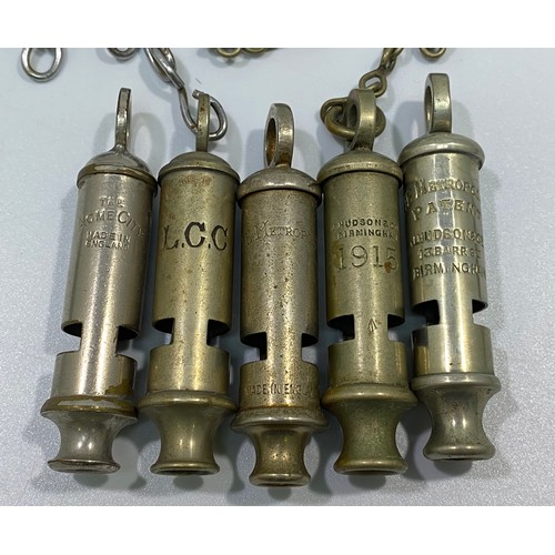 556 - Six various whistles including LCC, a 1915 dated example with chain and button hook, ACME Metropolit... 