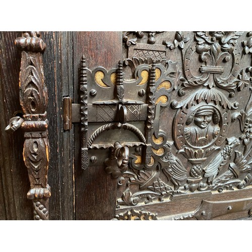 287 - A 19th century continental profusely carved and stained oak cabinet in the renaissance revival style... 