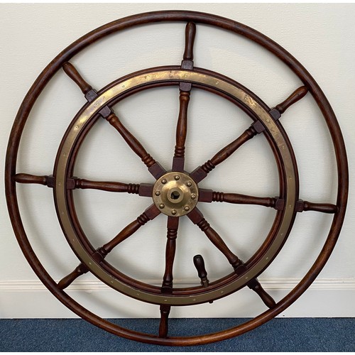 399 - A large stained oak ships wheel with brass ring and hub mounts, reputedly from a Zanzibar sloop, app... 