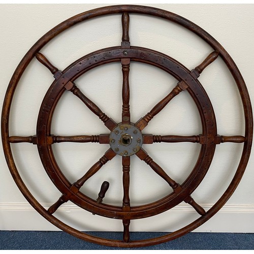 399 - A large stained oak ships wheel with brass ring and hub mounts, reputedly from a Zanzibar sloop, app... 