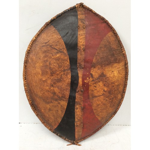 413 - An early 20th century Maasai shield, Kenya hide with painted with red ochre and black geometric deco... 