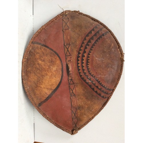 415 - A Maasai shield Kenya hide with painted with red, white, blue, black and yellow geometric decoration... 