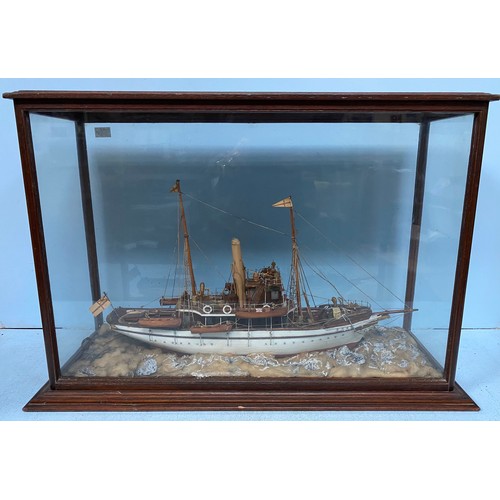 460 - A painted wooden waterline model of an early 20th century single screw steam yacht, in glazed wooden... 