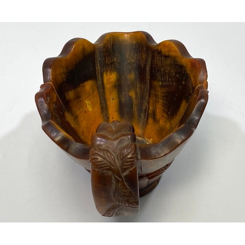 33 - A Chinese carved horn libation cup, carved with foliage, 7cm high