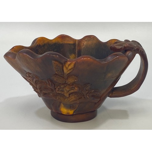 33 - A Chinese carved horn libation cup, carved with foliage, 7cm high