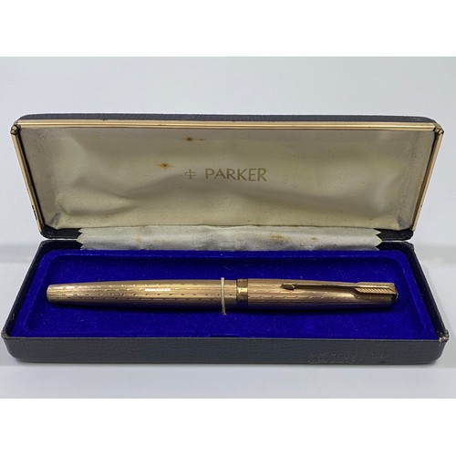 193 - A 9ct gold Parker pen with engine turned decoration, engraved ‘M McD’ marked ‘375’, lid marked ‘Park... 