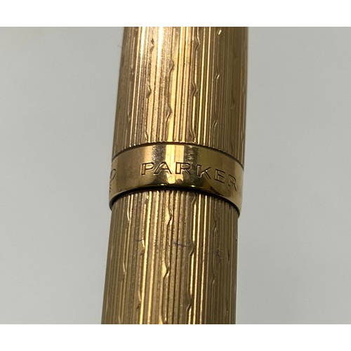 193 - A 9ct gold Parker pen with engine turned decoration, engraved ‘M McD’ marked ‘375’, lid marked ‘Park... 