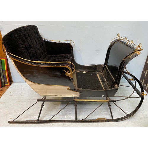 201 - A full size reindeer / horse sled / sleigh with black velvet upholstery and cream, black and gold pa... 