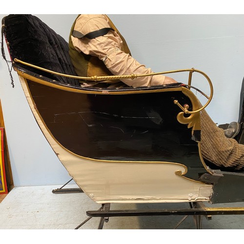 201 - A full size reindeer / horse sled / sleigh with black velvet upholstery and cream, black and gold pa... 