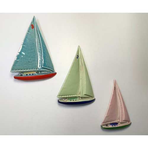 431 - A set of three porcelain yachts by Wade of Ireland, in original box