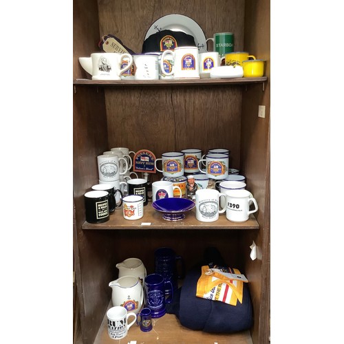 433 - Three shelves of Pusser’s Rum / maritime related items including metal mugs, cups, plates, cap, rule... 