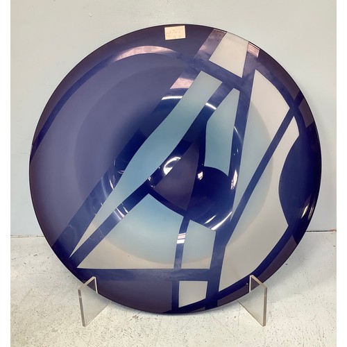 19 - Linda Charles (Contemporary) a very large glass display plate with blue geometric design, together w... 