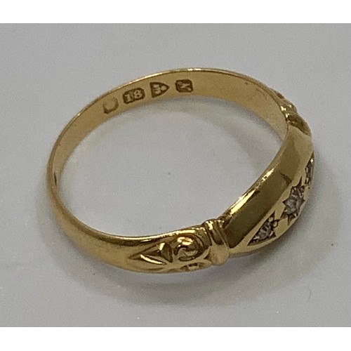 112 - An 18ct gold ring gypsy set with three small diamonds, 2.9g, ring size N