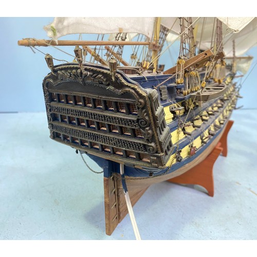 571 - A large hand built model of HMS Victory fully rigged with Nelson standing on the bow, raised on wood... 