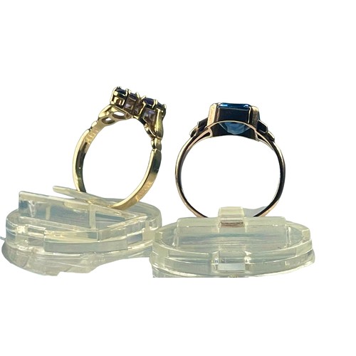 123 - Two yellow gold rings, set with blue stones, weighing a total of 4.4 grams. Ring sizes square stone ... 