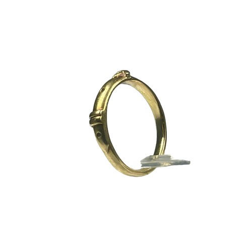 80 - A yellow gold ring, unmarked, possibly 18ct gold, in a buckle design, ring weighs 3.2 grams, finger ... 