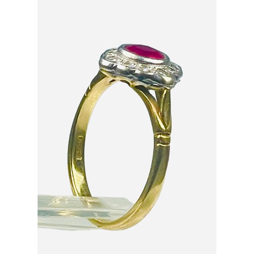 83 - An 18ct yellow gold dress ring, set with a round faceted ruby to the centre, and 12 x small round br... 