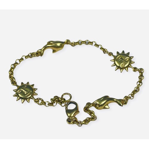 91 - An 18ct yellow gold bracelet, with dolphin and sun charms connecting to belcher links, weighing 6.9 ... 