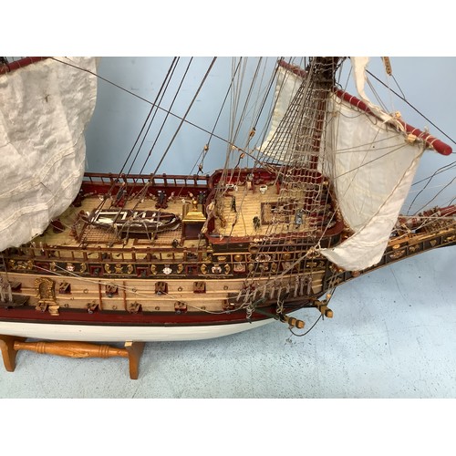 570 - A hand-built model of a fully rigged ship with detailed deck, figures, guns and well painted, 100cm ... 