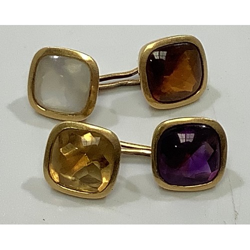 114 - A pair of yellow metal cufflinks, (testing as 18ct or above), each set with a cushion-cabochon cut a... 