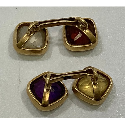 114 - A pair of yellow metal cufflinks, (testing as 18ct or above), each set with a cushion-cabochon cut a... 