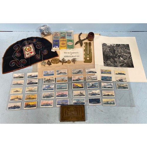 490 - A mixed lot of military collectables including cap and shoulder badges, trench-art kukri knife sciss... 