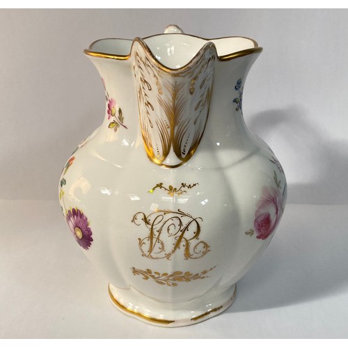 576 - A 19th century porcelain jug, painted with flowers and with a gilt monogram 'VR', 19cm high, reputed... 