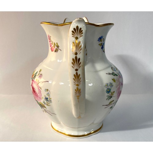 576 - A 19th century porcelain jug, painted with flowers and with a gilt monogram 'VR', 19cm high, reputed... 