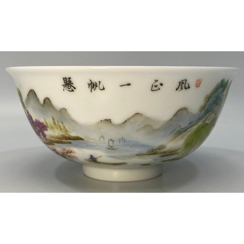 38 - A Chinese porcelain bowl hand painted with a scene of a figure of a man on a raft with houses, trees... 