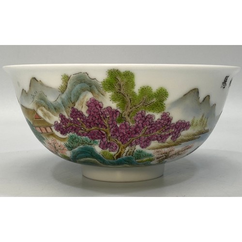 38 - A Chinese porcelain bowl hand painted with a scene of a figure of a man on a raft with houses, trees... 