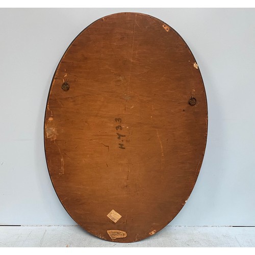 615 - A Liberty & Co Arts & Crafts oval mirror with hammered copper frame, inset with heart shaped pottery... 