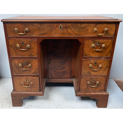 637 - An 18th century and later mahogany kneehole desk of small proportions, tan leather gilt tooled scrib... 