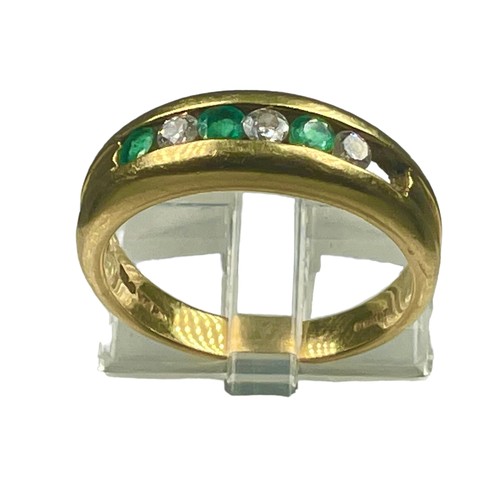 284 - An 18ct yellow gold emerald and diamond ring, channel set with three diamonds and three emeralds, (o... 