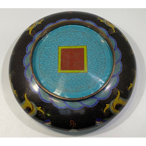 51 - A Chinese Cloisonné bowl of shallow compressed circular form, decorated with a five-claw dragon and ... 