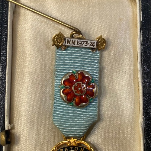 216 - A 9ct gold Masonic jewel for Paton Lodge No. 3738 and bar ‘W.M. 1973-1974’ with poppy badge on blue ... 